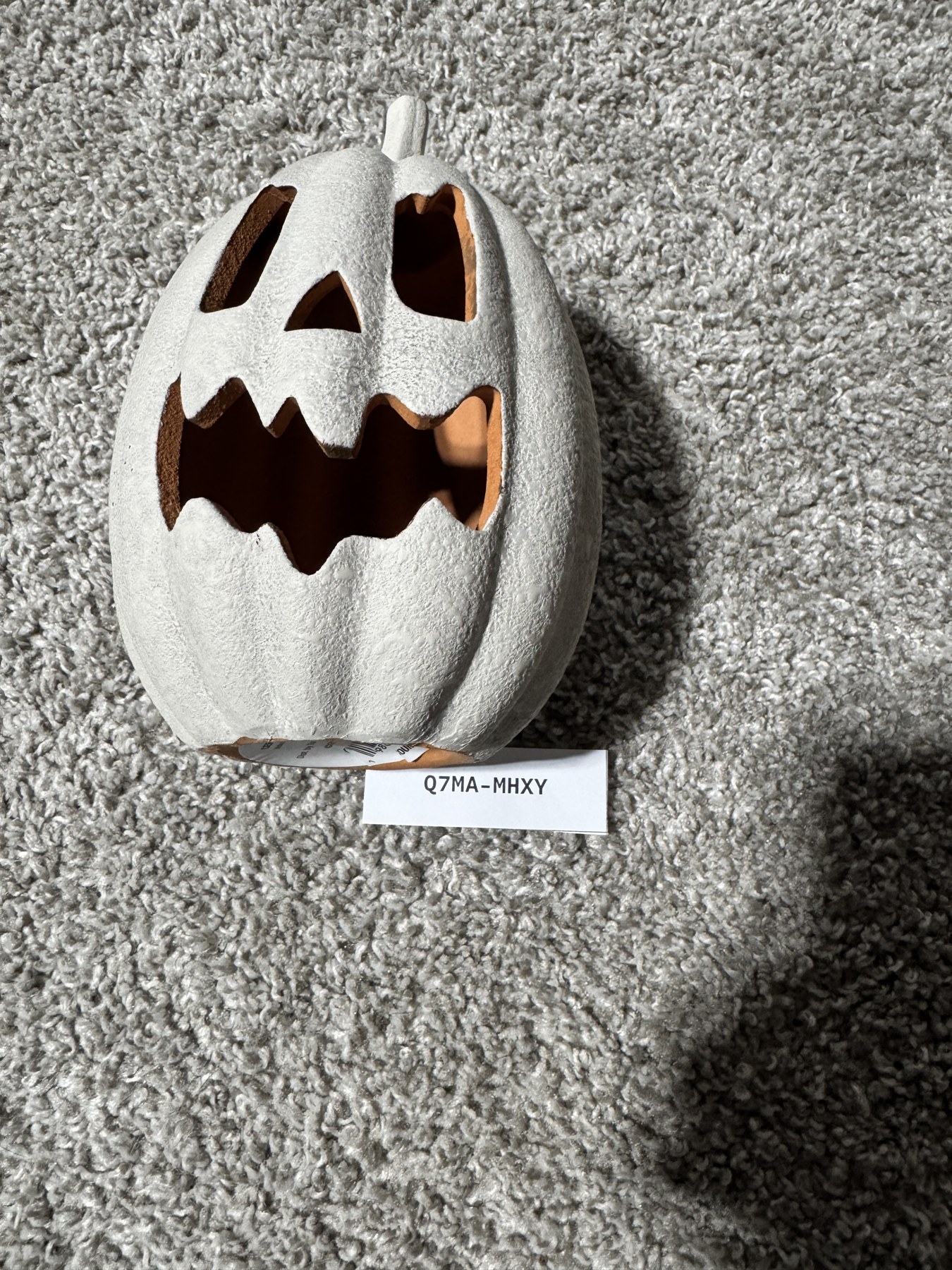 The hidden target for identifier Q7MA-MHXY: a ceramic jack-o'-lantern.