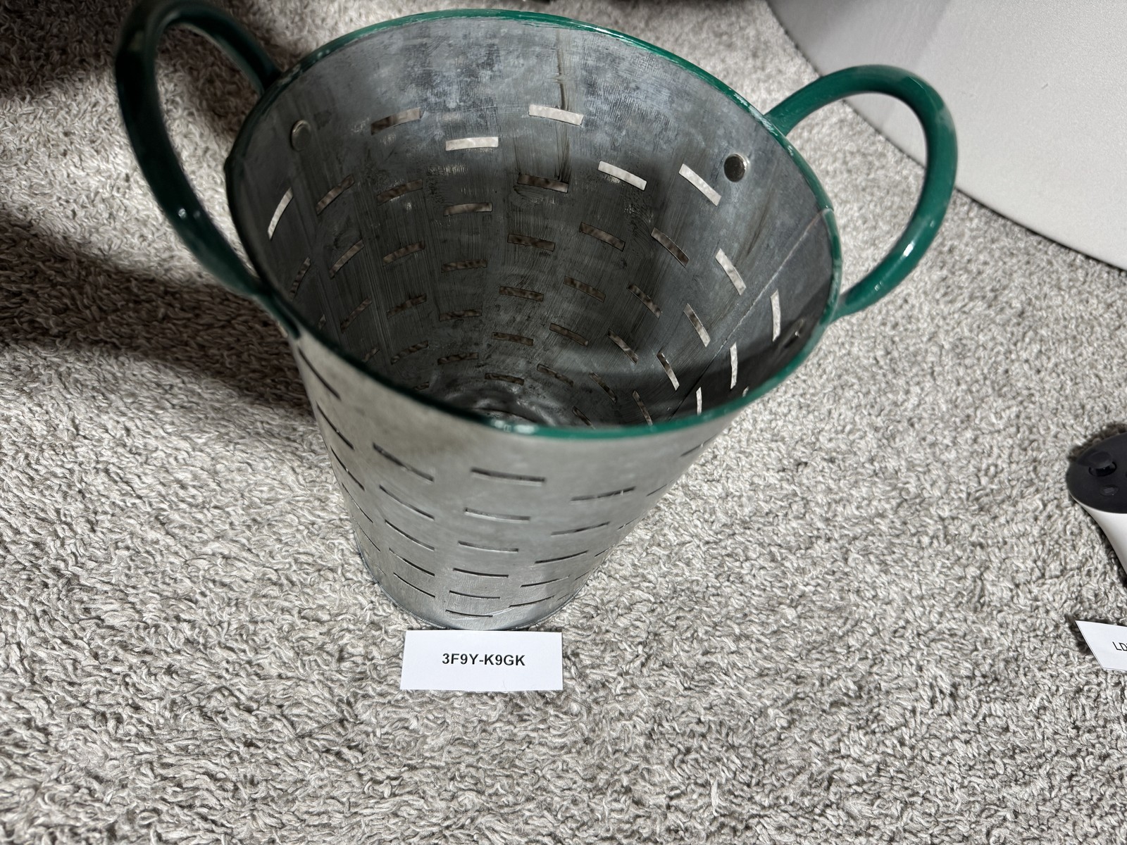 The hidden target for identifier 3F9Y-K9GK: a perforated metal bucket.